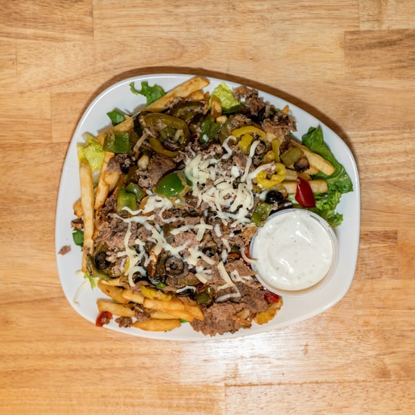 Cheesesteak fries with peppers, onions, olives, and shredded cheese, served with a side of ranch.