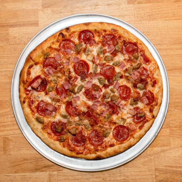 A freshly baked Papa V's Pizzeria meat lover's pizza with pepperoni, ham, and sausage.